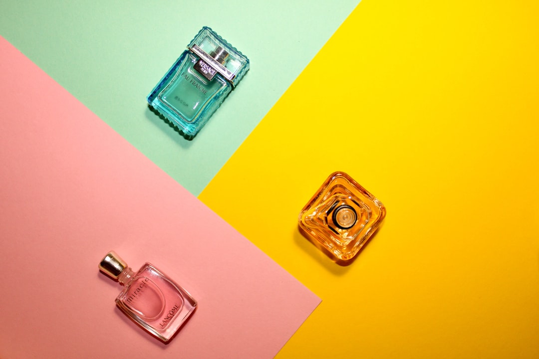 A collection of elegant perfume bottles arranged artfully, showcasing different colors and shapes, with a soft background to emphasize the fragrances.
