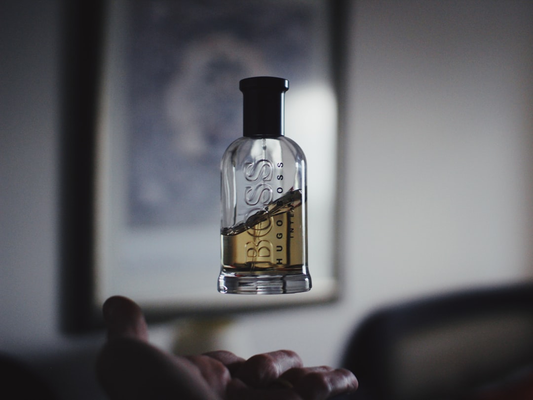 A serene setting with various perfume bottles and a person thoughtfully choosing a scent.