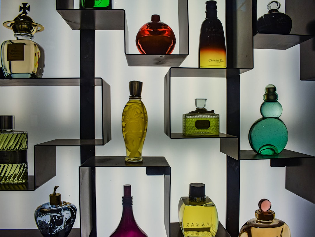 A visually appealing arrangement of various perfume bottles on a table, showcasing different shapes and colors.