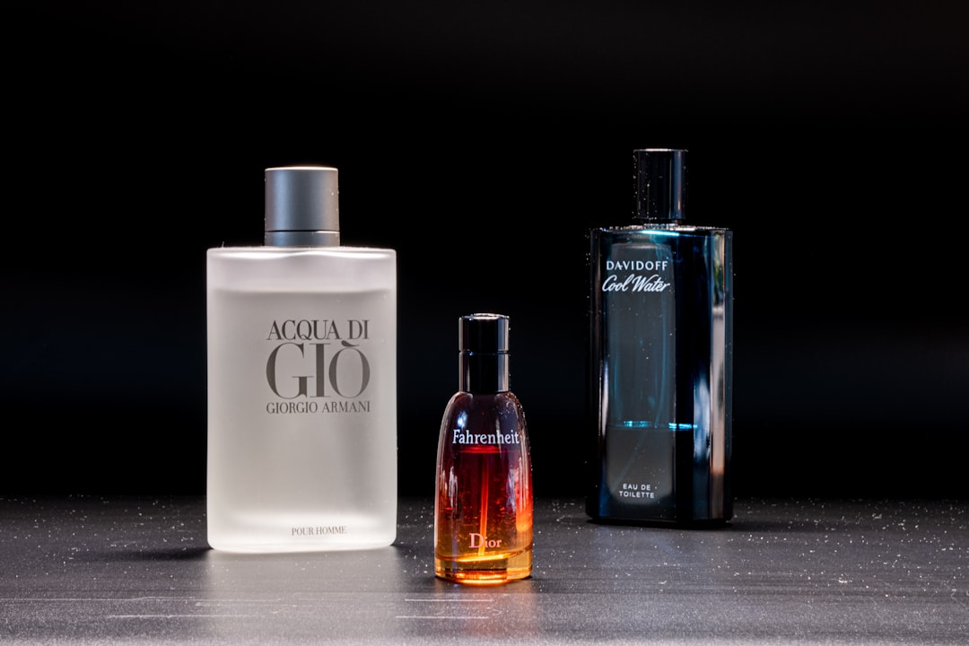 A close-up of elegant perfume bottles with soft lighting, showcasing the difference in design and size between Eau de Parfum and Eau de Toilette.